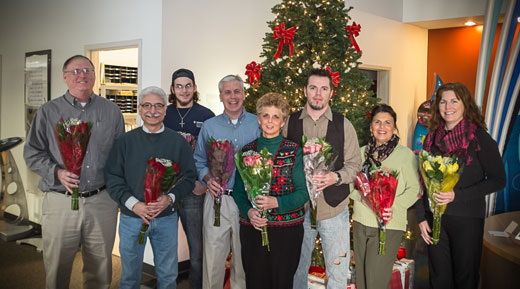 Employees hold flowers