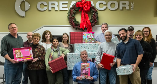 Employees gathered holding presents