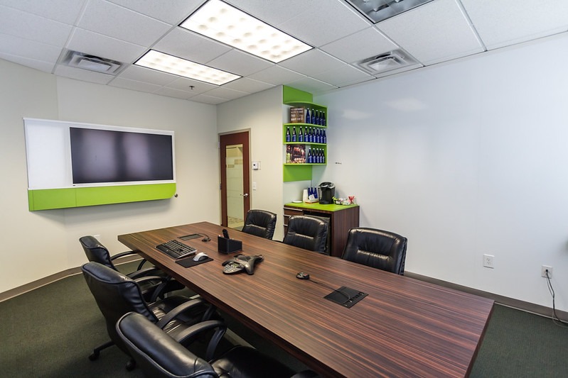 facilities-1 conference room with large table and TV on the wall