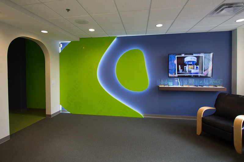 facilities-2 large logo design backlit on wall with shelf for awards